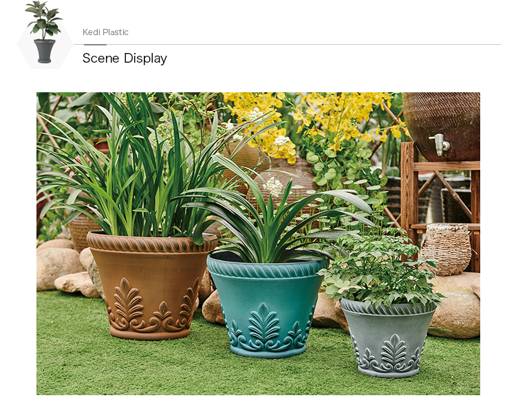 Decorative round plastic planters with green plants in an outdoor garden